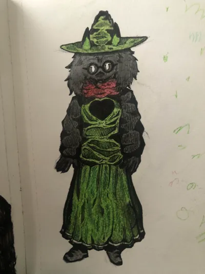 A marker and ink drawing of a witch in a green dress and wide hat with round glasses